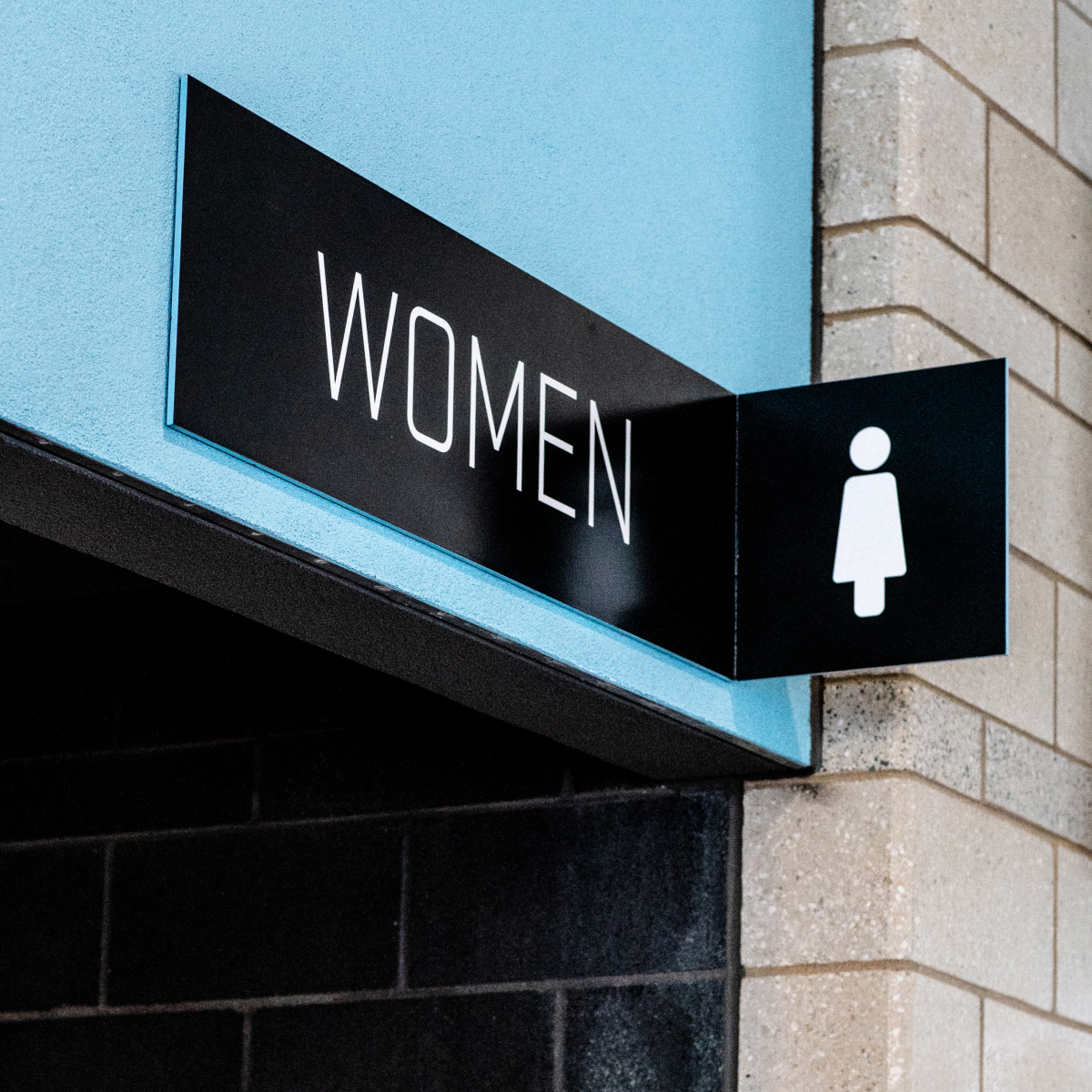 Signage above the restrooms at Allianz Field. The blade sign has the restroom label with a section of the metal that protrudes out with a custom icon.