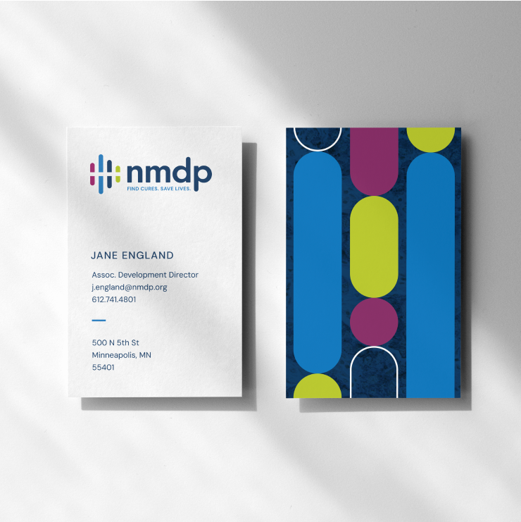 The front and back of business cards for NMDP, featuring their new identity system