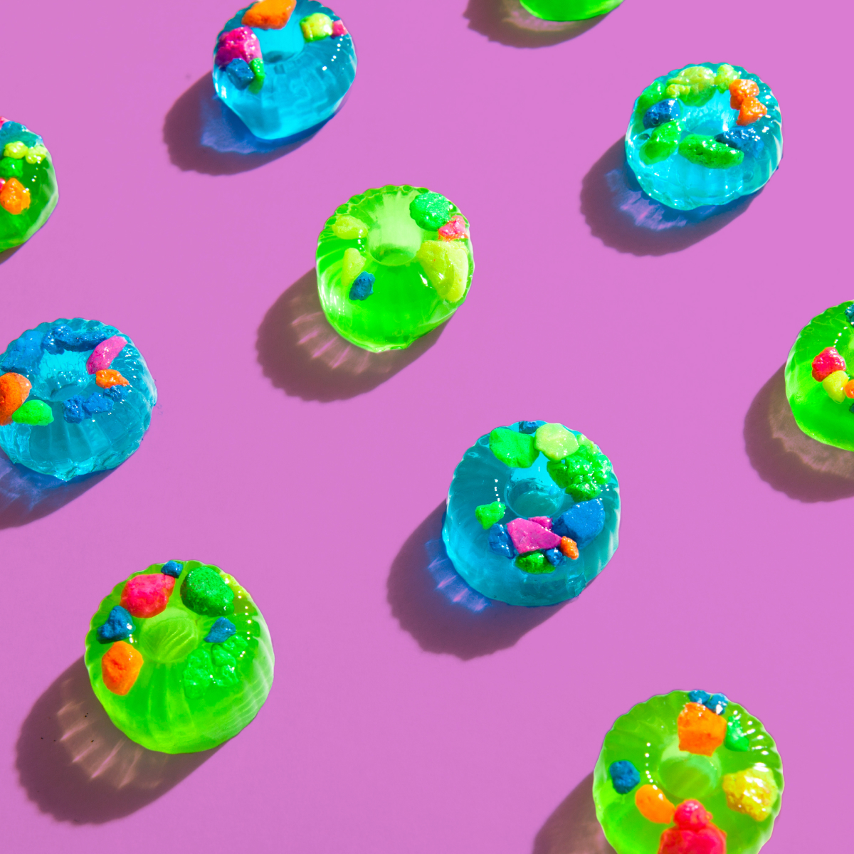 Early prototypes of Nerds Gummies on a bright purple backdrop.