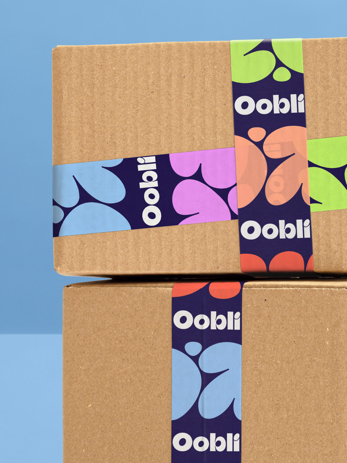 Two stacked cardboard shipping boxes, sealed with tape featuring the Oobli logo and graphics.