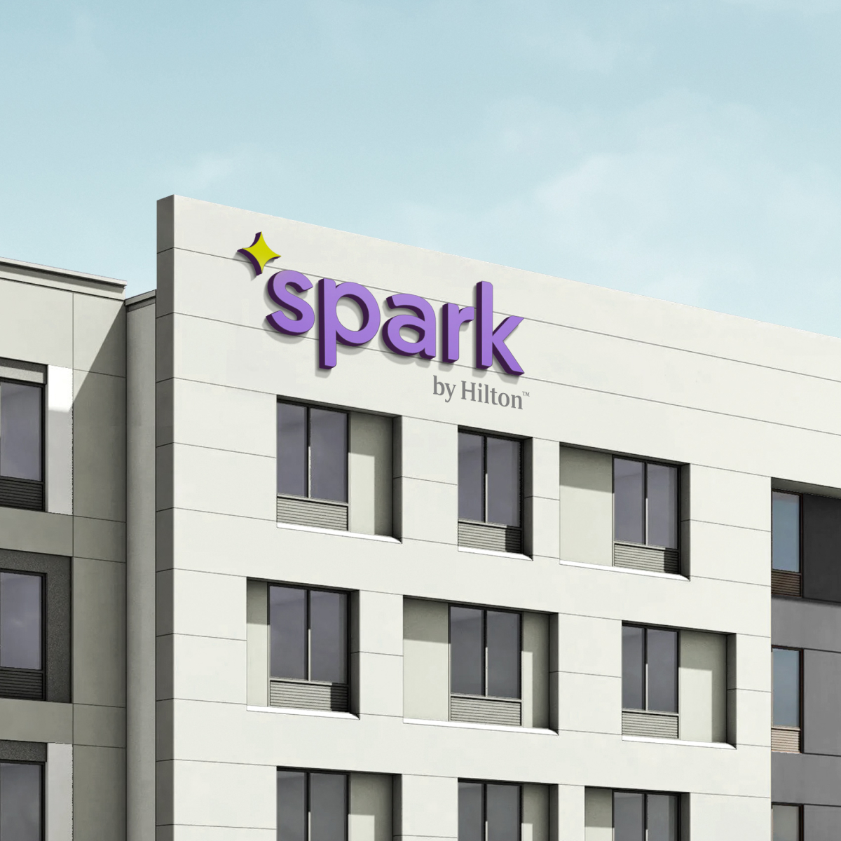 The Spark by Hilton logo applied to the side of the hotel building