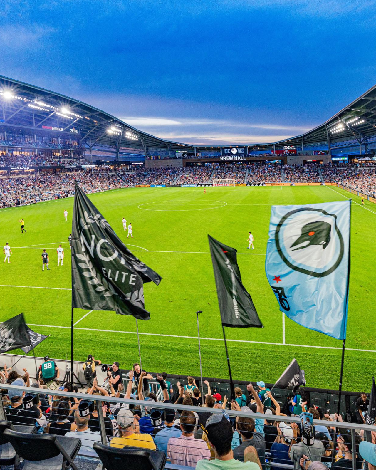 Supporters groups  waving their flags in front of a match at Allianz field.